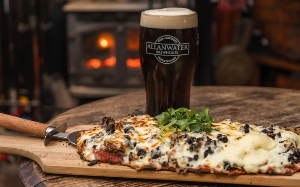 pizza and stout, with stove in background