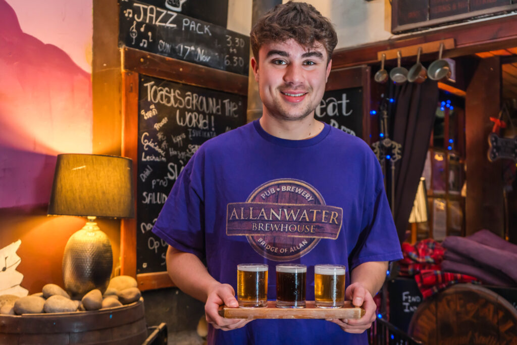Friendly staff member holding drinks