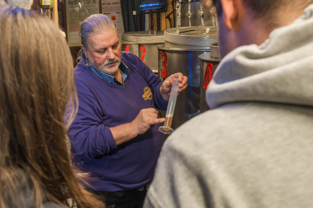 Douglas with a test tube showing how the brewing process works