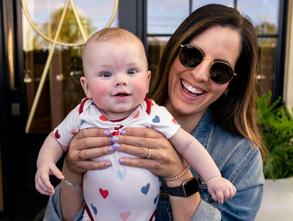 mother holds baby in cafe