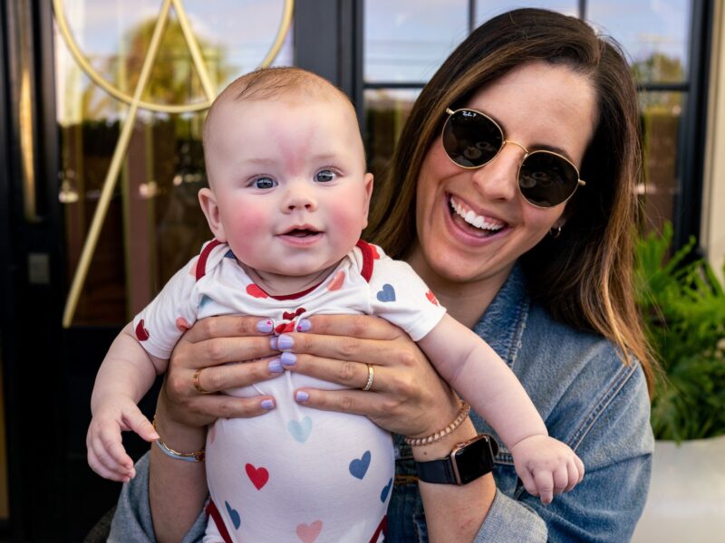 mother holds baby in cafe