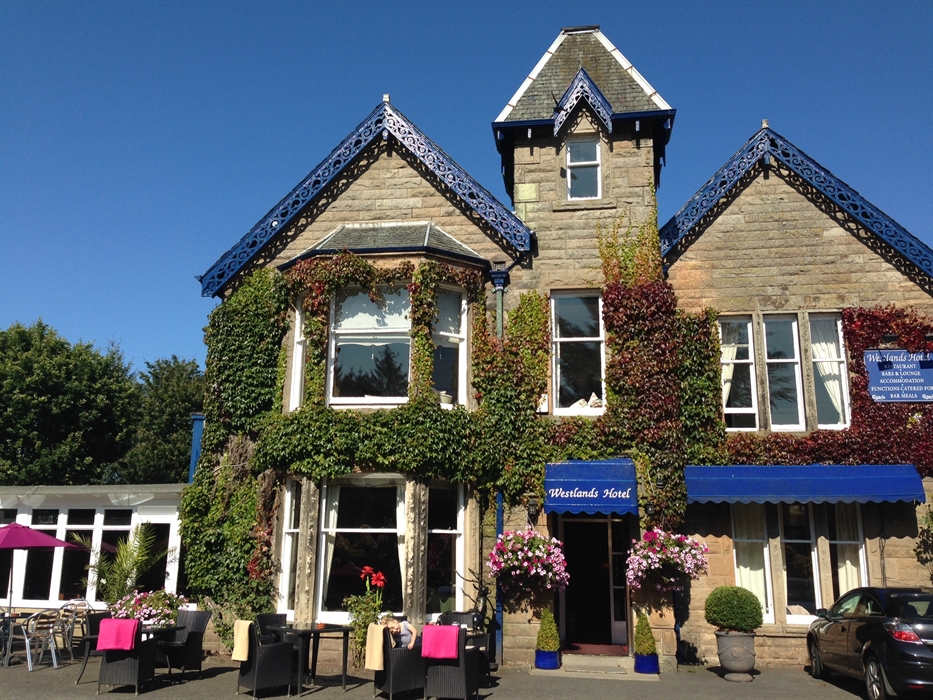 exterior shot of the westlands, a victorian building with a blue canopy