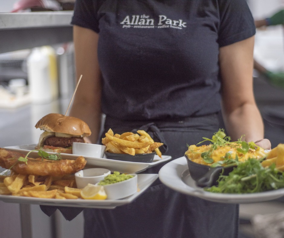 Server holding plates of food