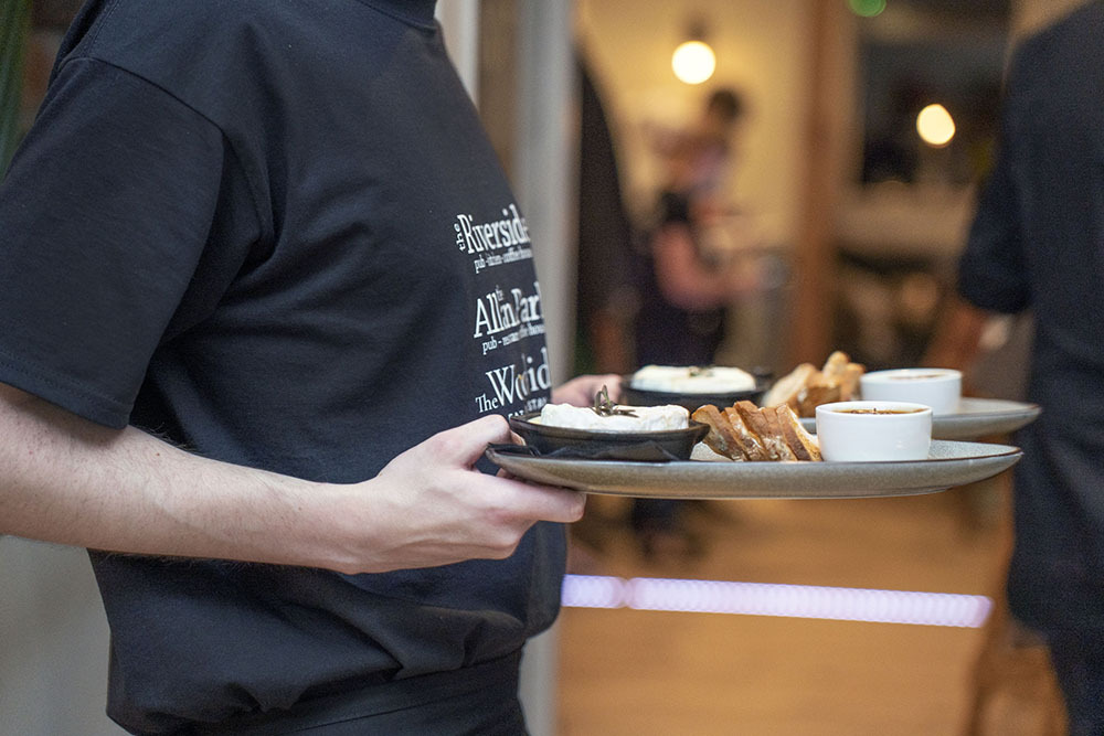 Dinner plates being held by server