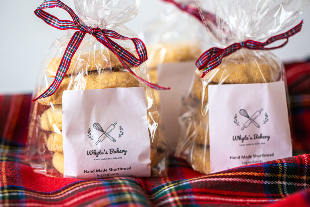 Two shortbread bags tied with tartan ribbon